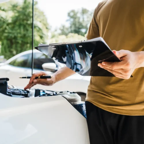 man-fills-out-a-car-insurance-form-after-a-car-acc-2025-03-08-00-14-29-utc